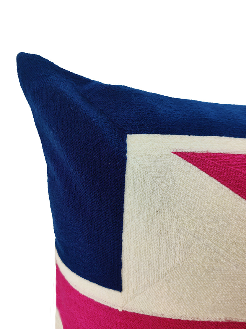 A close-up of the RAMSHA HOME Multi Color Embroidery Cushion CS-271 shows its geometric navy blue, white, and bright pink pattern on textured fabric, creating a stylish accent against a plain white background.