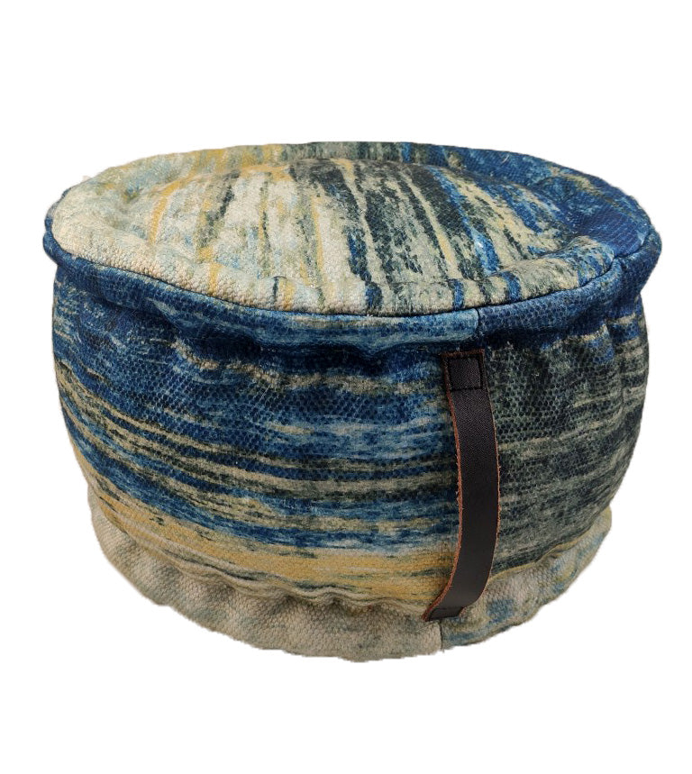 The RAMSHA HOME Printed Multi Color Pouf With Leather Handle features a blue, yellow, and beige marbled design, soft plush polyester fabric, and a brown leather side handle for easy carrying.