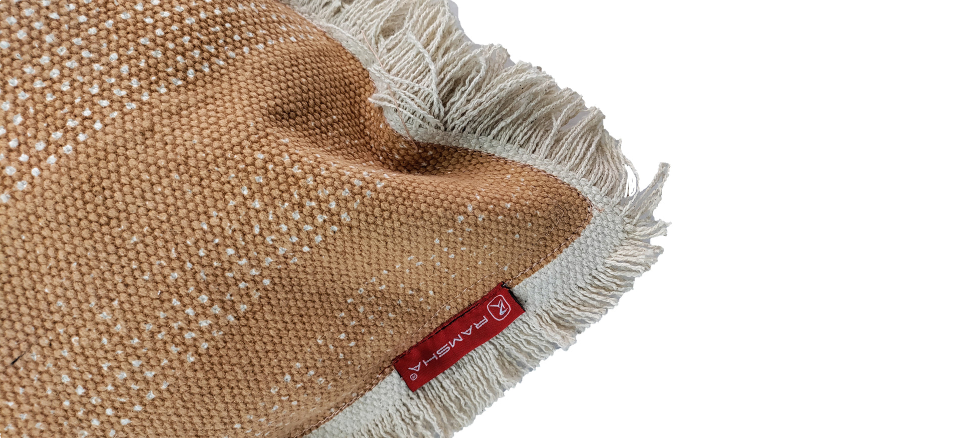 A close-up of the Cotton Cushion With Fringes cs-141 by RAMSHA HOME, featuring woven brown and cream cotton, white fringed edges, and a red fabric label, displayed on a white background.