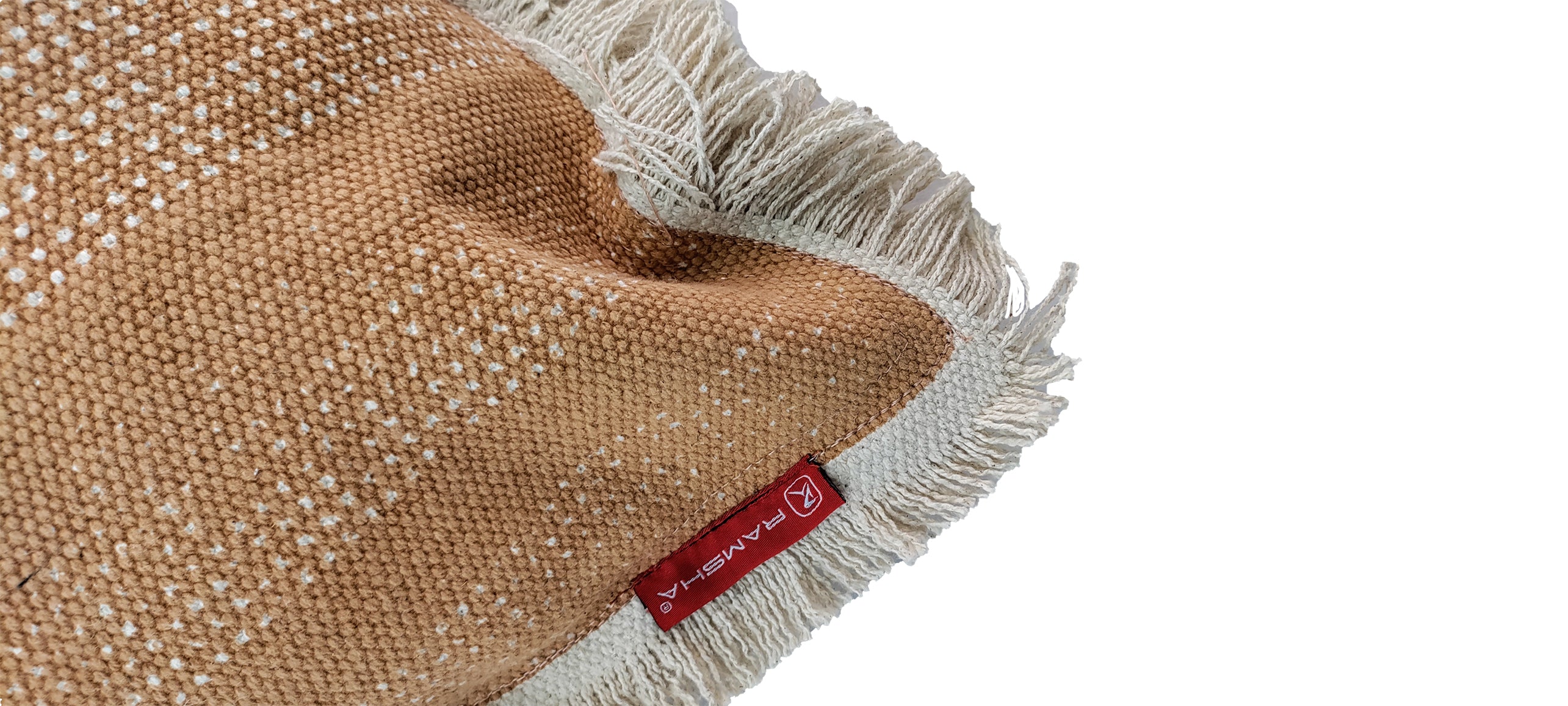 A close-up of the Cotton Cushion With Fringes cs-141 by RAMSHA HOME, featuring woven brown and cream cotton, white fringed edges, and a red fabric label, displayed on a white background.