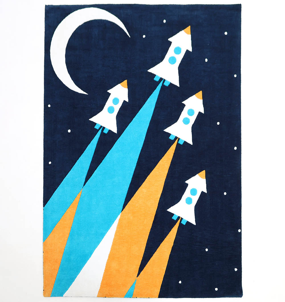 The RAMSHA HOME Kids Space Rocket Polyester Playroom Rug KD-001 (170x240cm) features four rockets with blue and orange trails heading toward a crescent moon on a starry dark blue background—ideal for any child’s bedroom.