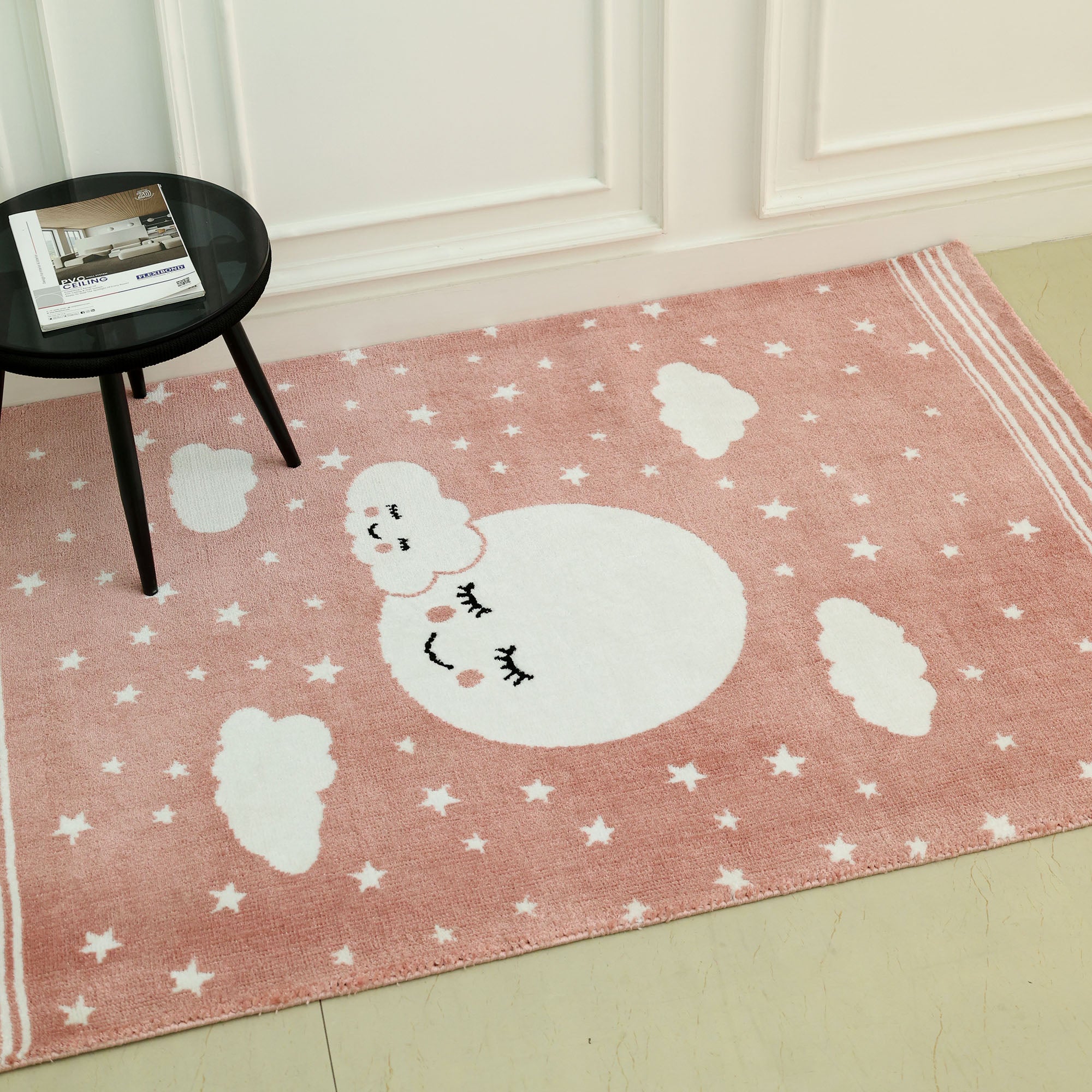 The RAMSHA HOME Kids Rug Soft Star & Sky Pink Color Nursery Rug (120x180 cm – KD 019) features white stars, clouds, and a smiling moon with closed eyes—perfect for adding charm to any nursery or child's room.