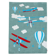 The RAMSHA HOME Kids Rug Soft Multi Color Nursery Rug 120x180 cm – KD 020 features vintage biplanes and hot air balloons in red, white, and blue among clouds on a soft blue background—ideal for nurseries or playrooms.