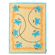 The RAMSHA HOME Kids Rug Soft Multi Color Nursery Rug 120x180 cm (KD 022) features a blue border, six blue butterflies, orange leafy vines, and curved black dashed lines—creating a charming accent perfect for nursery décor.