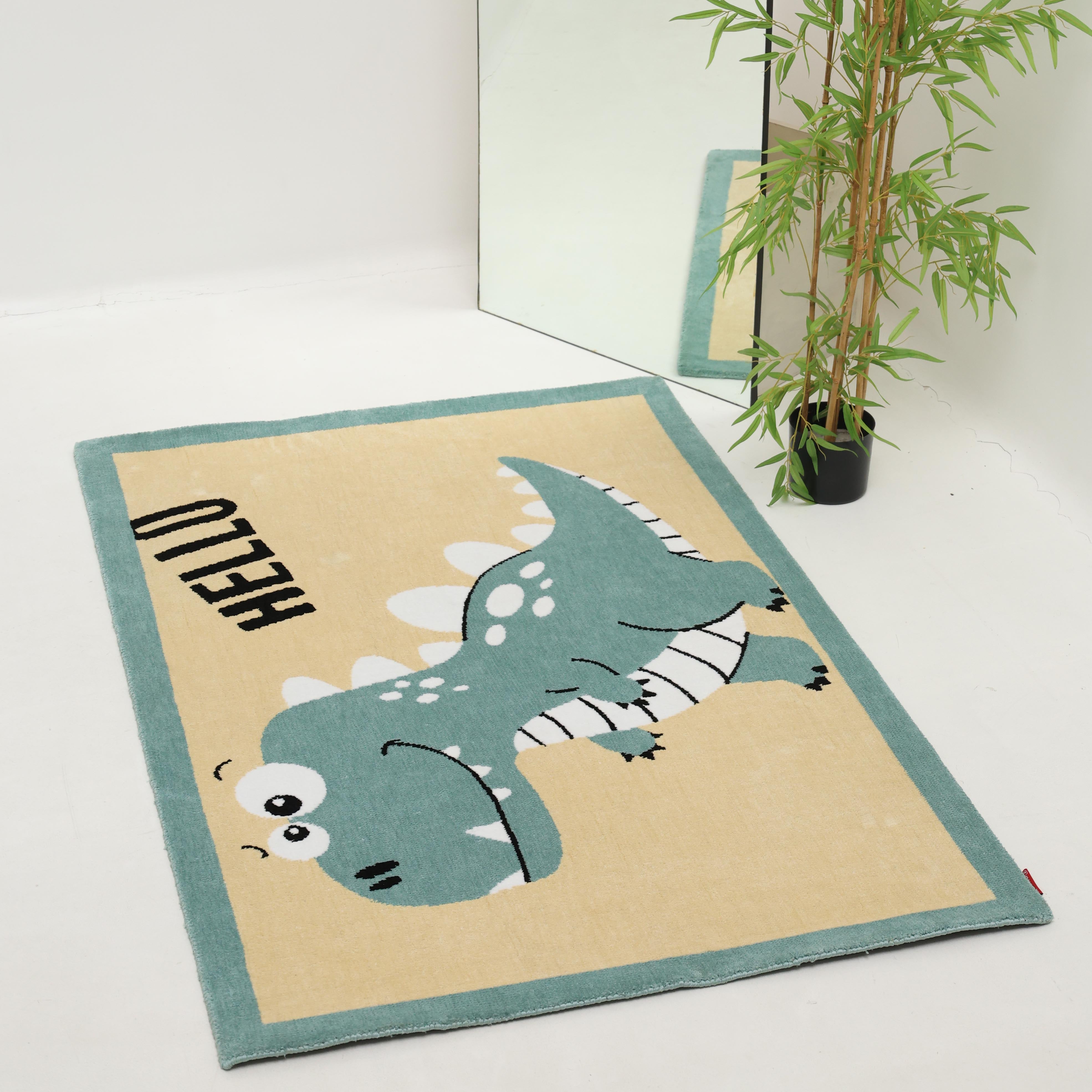 The RAMSHA HOME Kids Rug Soft Dinosaur Character Rug (120x180 cm – KD 018) features a playful dinosaur and "HELLO" in black letters, creating a cheerful accent for any kids room.