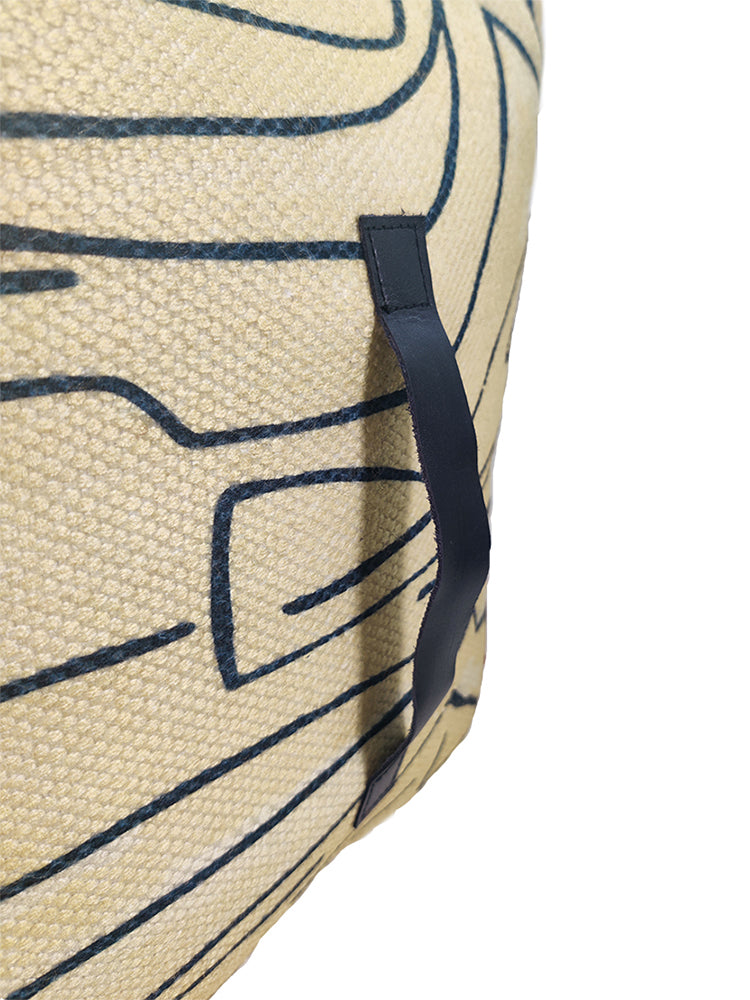 Detailed view of handmade beige pouf highlighting vibrant printed pattern