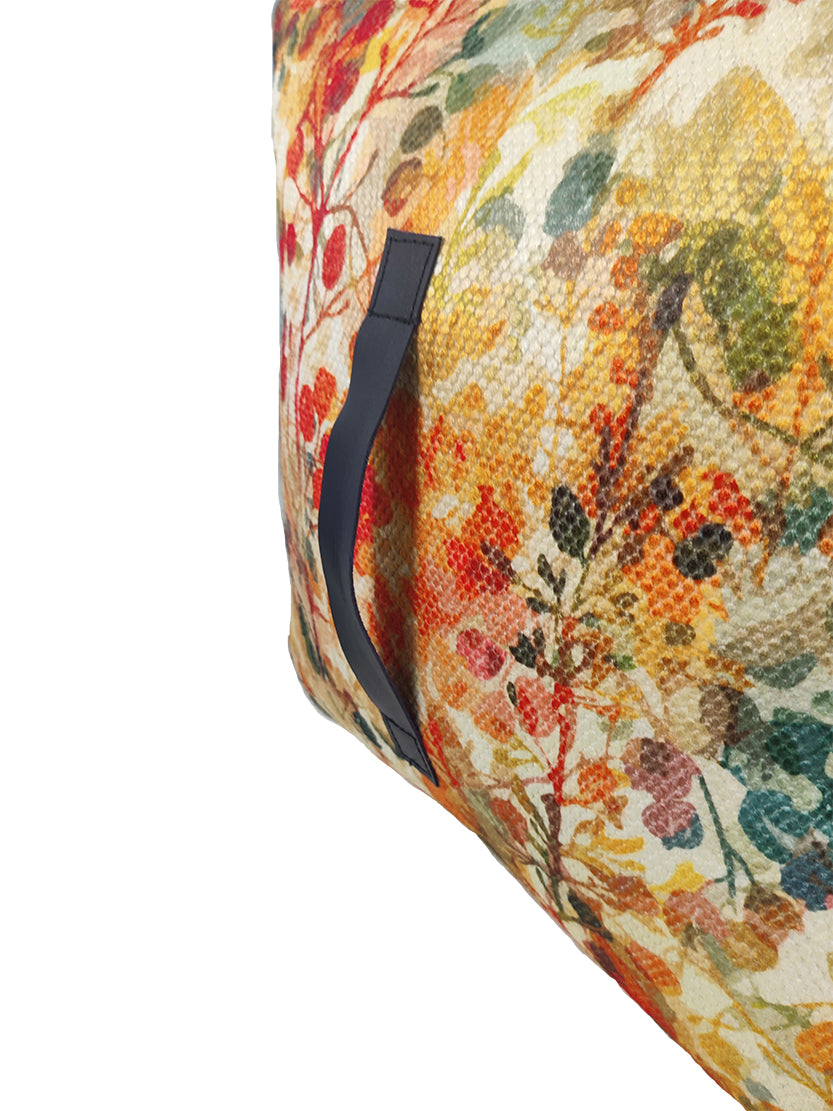 Detailed view of handmade red multi-colored pouf highlighting colorful pattern