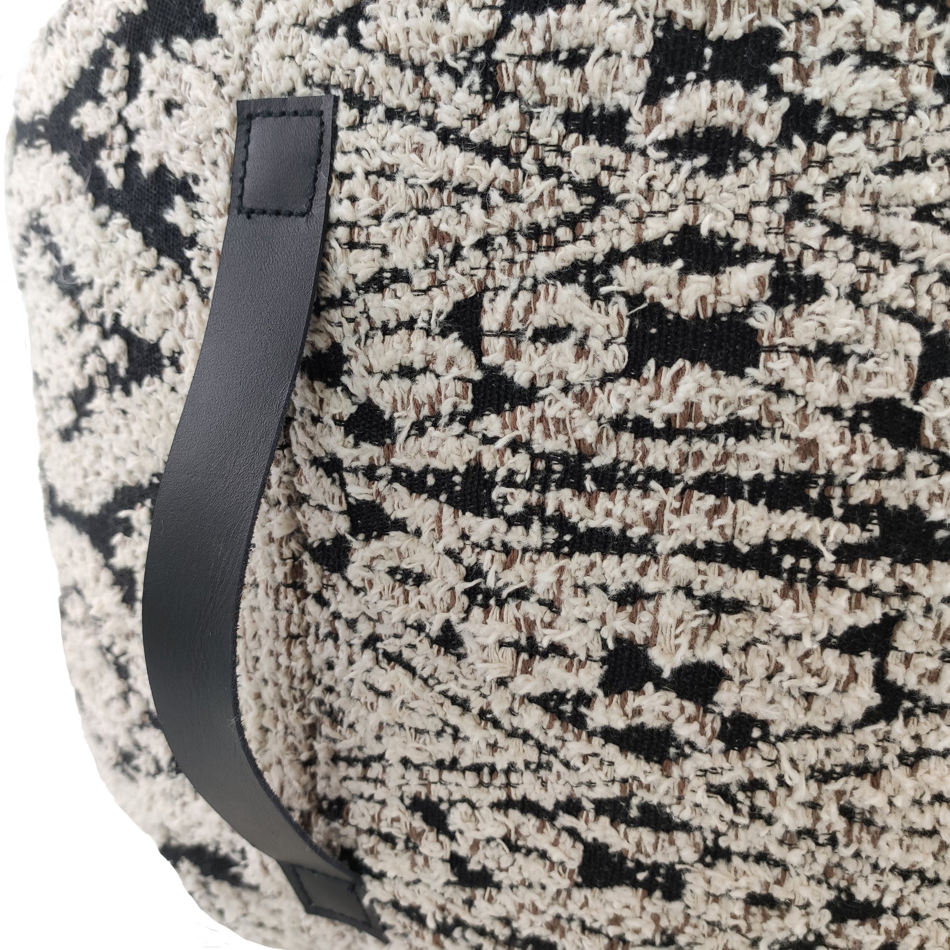 Close-up of black & white cotton pouf showing soft woven texture and handle