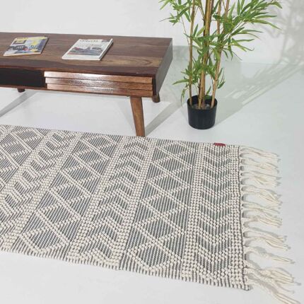 Masterpiece Woven Rug in Interior Room with Wooden Desk and Plant - Ramsha Home