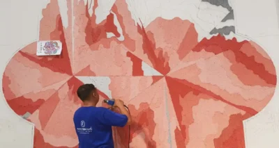 Artisan weaving a custom rug by hand-tufting techniques