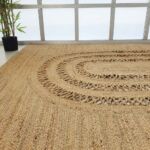 Handmade Living Room Circle Jute Rug - BR 085 showcasing its braided design in a cozy living room setup.