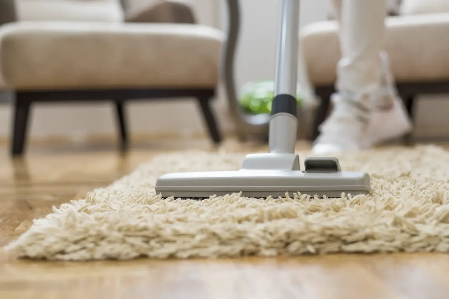 Vacuuming a carpet for professional rug cleaning Dubai