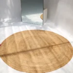 Handmade natural braided jute rug with eco-friendly design, rustic charm, and durable craftsmanship.