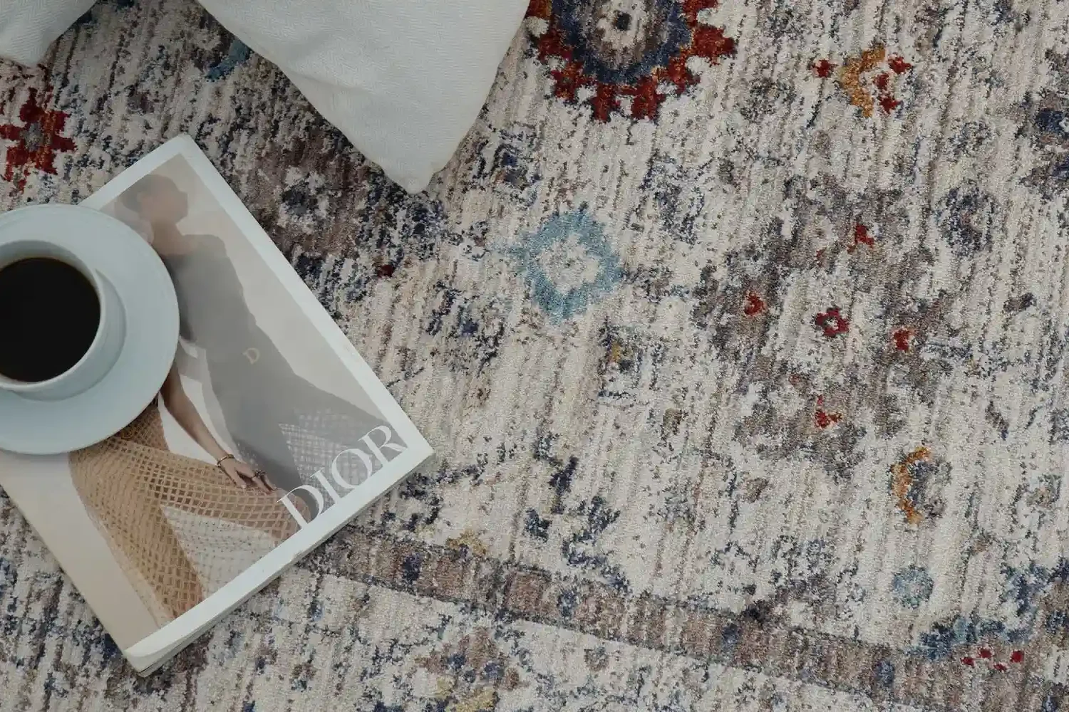 Beautifully designed living room featuring a hand-knotted patterned carpet, vibrant cushions, and a mix of geometric and floral motifs enhancing home design.