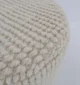 Decorative pouf for living room with stylish design, soft comfort, and versatile functionality.