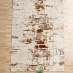 Machine-made rug with modern patterns, soft texture, and long-lasting durability for home décor.