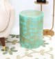 Round modern side table with turquoise dot pattern and golden iron base placed beside a couch