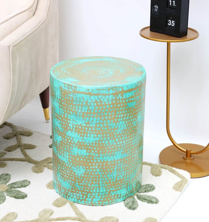 Round turquoise and gold coffee table beside couch – modern side table with vibrant design