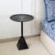 Modern black metal side table with textured round top and pyramid base – industrial accent table