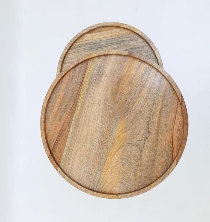 Top view of set of 2 wooden nesting side tables showing round solid wood tops and natural grain patterns