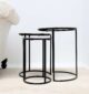 Side view of modern round coffee table with aluminium top and black iron legs – minimalist industrial design
