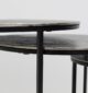 Side close-up of set of 3 modern nesting side tables showing antique brass tops and black iron bases