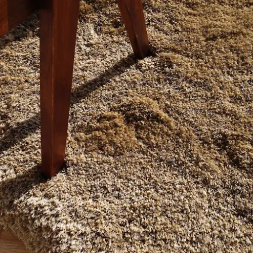 Close-up of brown shaggy rug showing soft texture and plush fibers