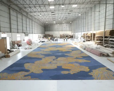 Large area rug in a manufacturing unit showcasing the production process for the blog ‘Large Area Rugs: Everything You Need To Know’