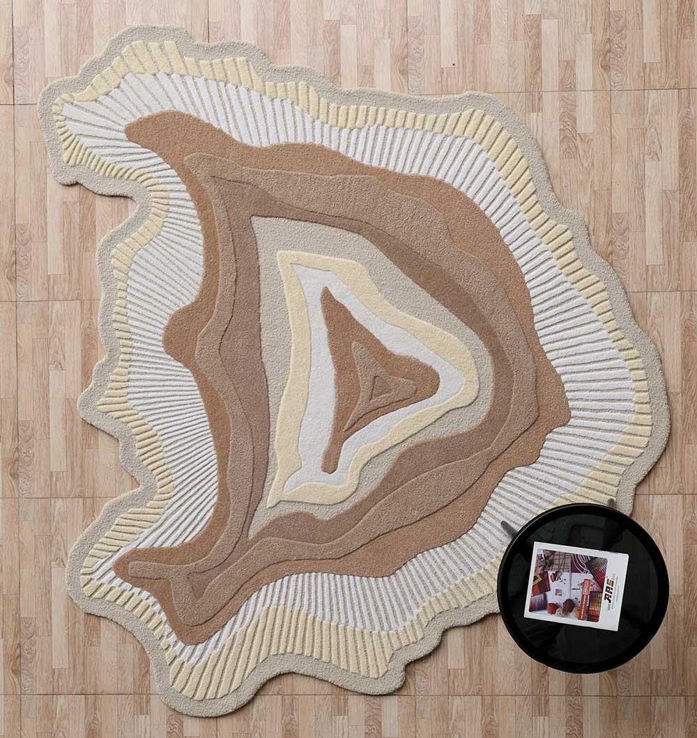Handmade Earth Tone Rug - HTW 124 (200cm) A Sculptural Earth Tone Rug with organic concentric layers in beige and cream, featuring hand-carved textured ridges on a wooden floor.