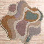 A Multicolor Shaped Area Rug with organic, wavy layers in earth tones like ochre, rose, and sage green.